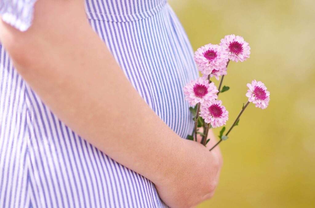 Pregnant Woman Holding Flowers Original
