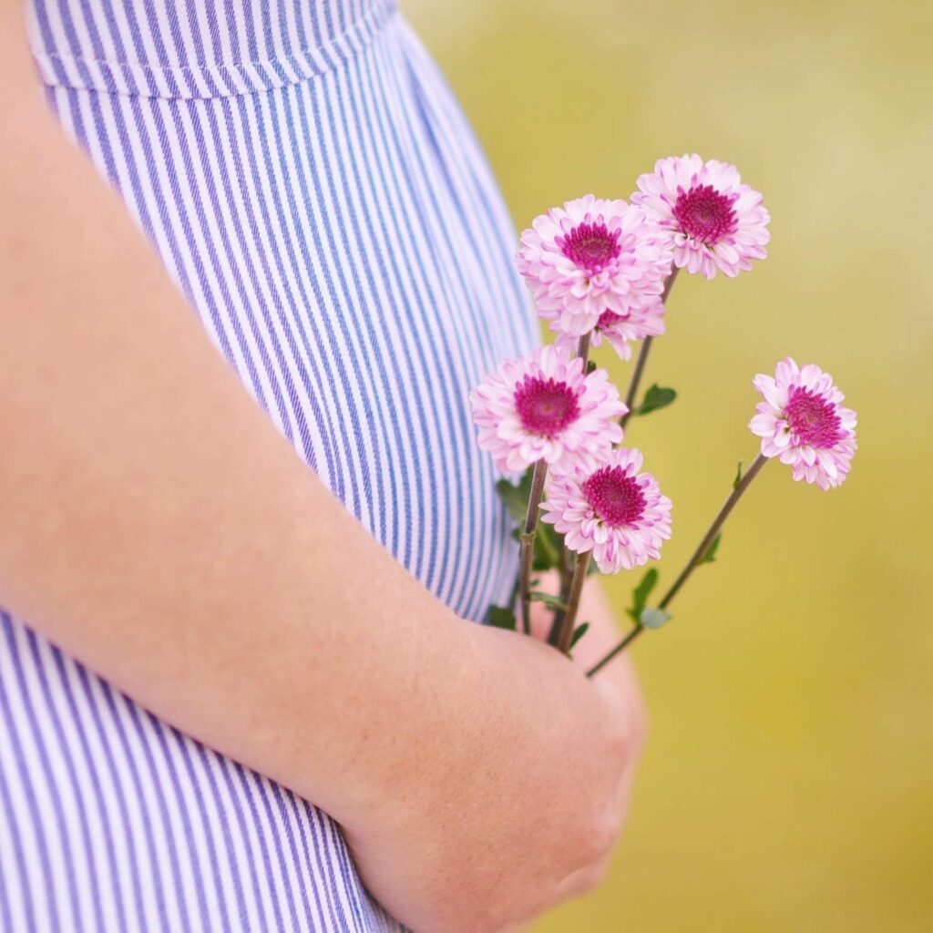Pregnant Woman Holding Flowers
